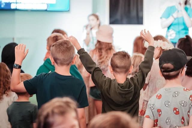 Kids worshipping during Base Camp service