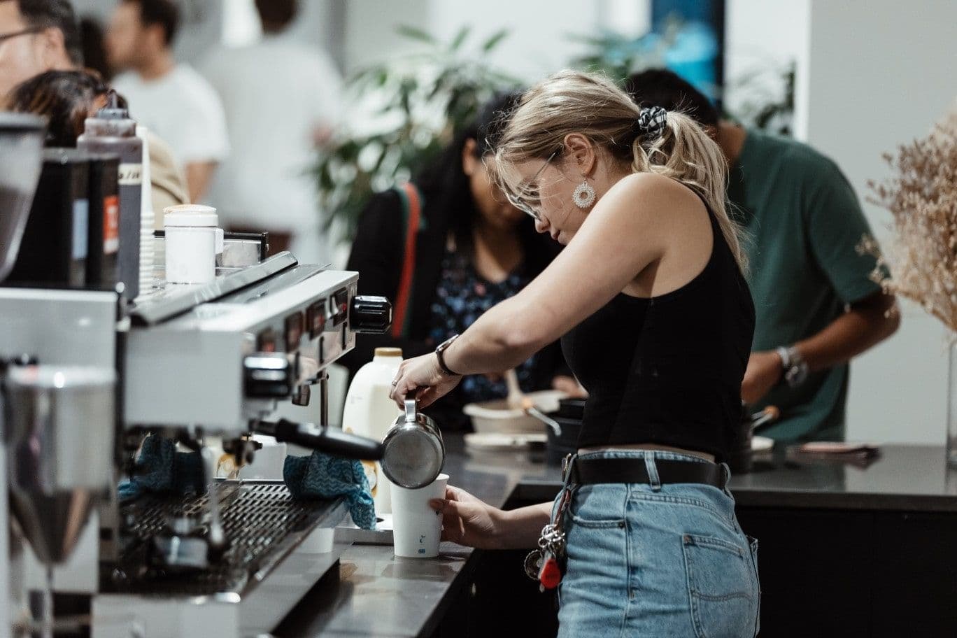 A woman makes a coffee