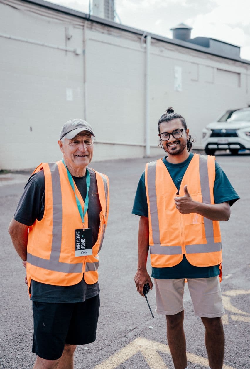 Two men serving on the carpark Team