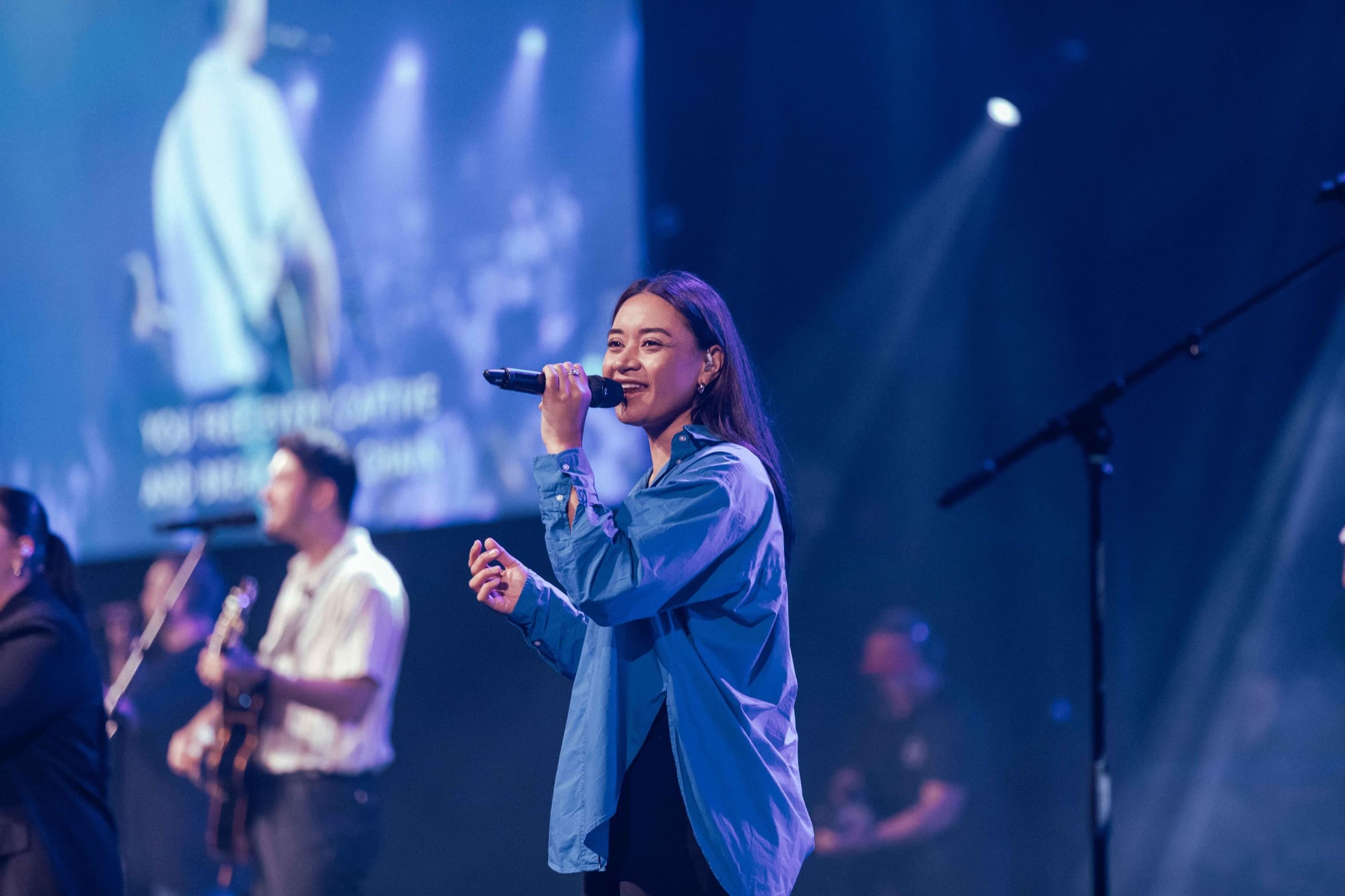 Worship team - singer worshipping at a Sunday service