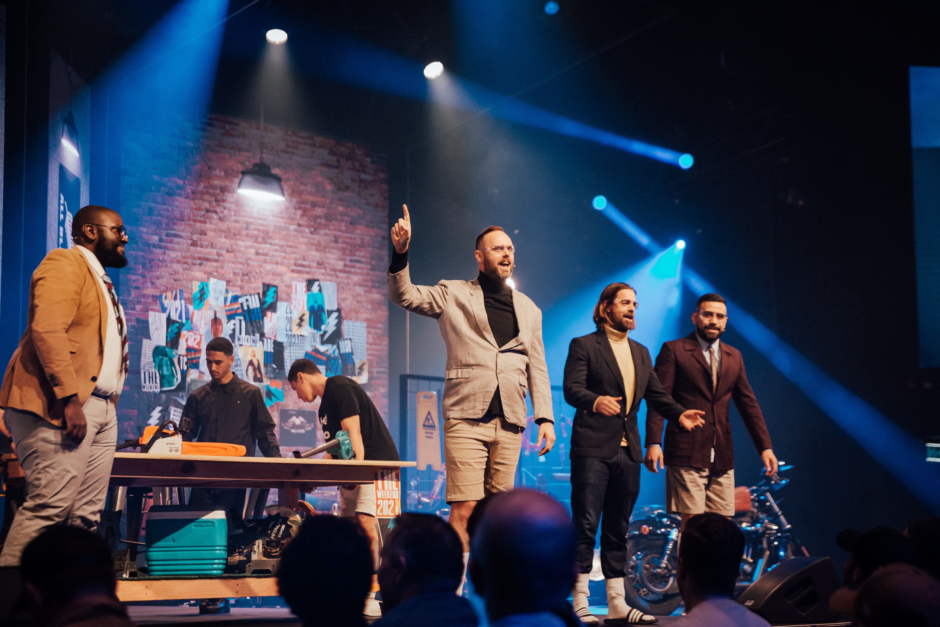 Hosts on stage for Men's Gathering in 2021