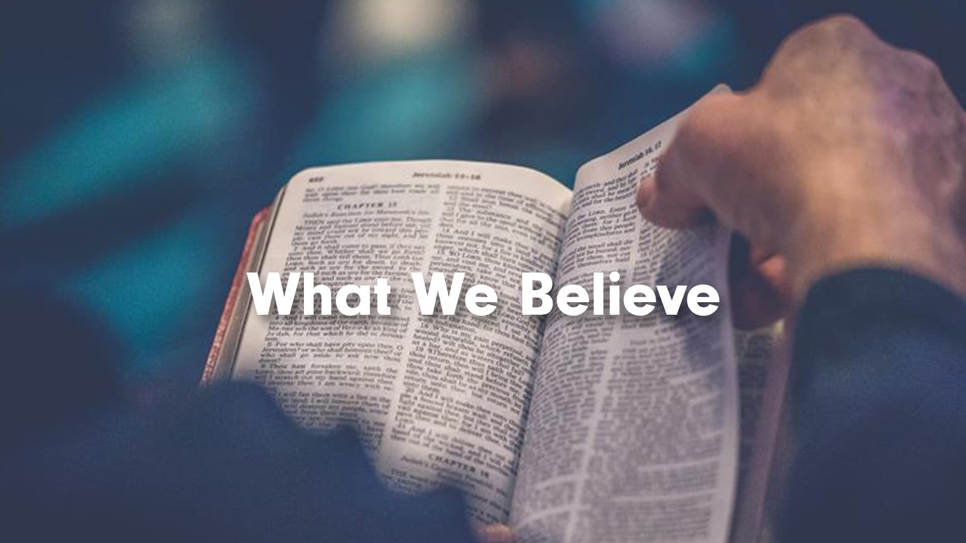 Person reading the bible with words WHAT WE BELIEVE over the top
