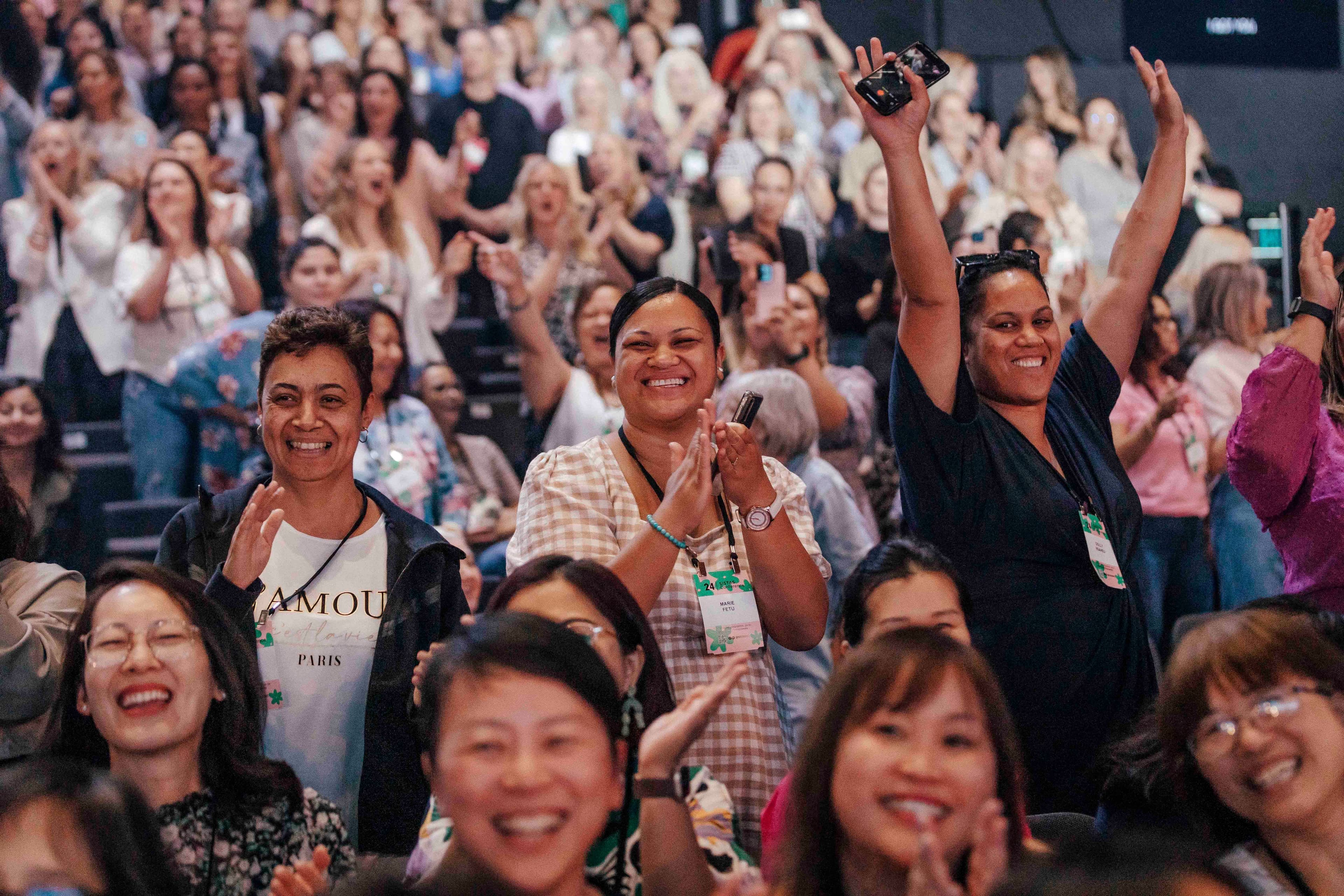 Audience full of women laughing and smiling
